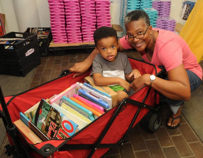 A teacher and her grandson at a Houston book distribution supported in part by Penguin Random House post-Hurricane Harvey