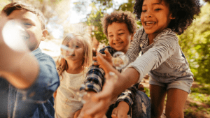 A group of four children playing outside.